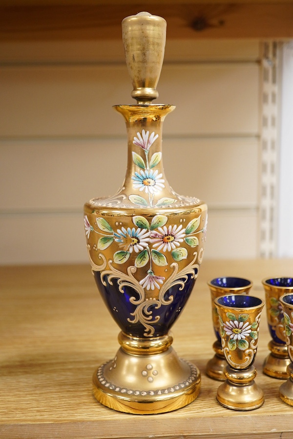 A Royal Worcester peacock painted jar and cover and a Bohemian blue glass decanter and six glasses, with gilt and enamel decoration, decanter 26cm high including stopper. Condition - finial to Worcester pot cover chipped